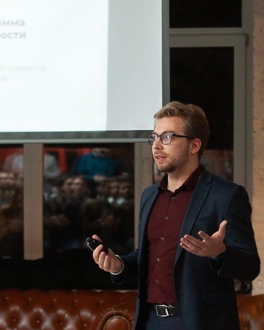 Stas Prodan speaking on stage at a conference